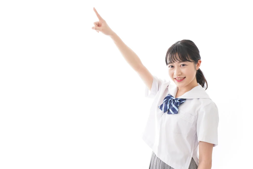 中学生が斜め上に指を刺している画像